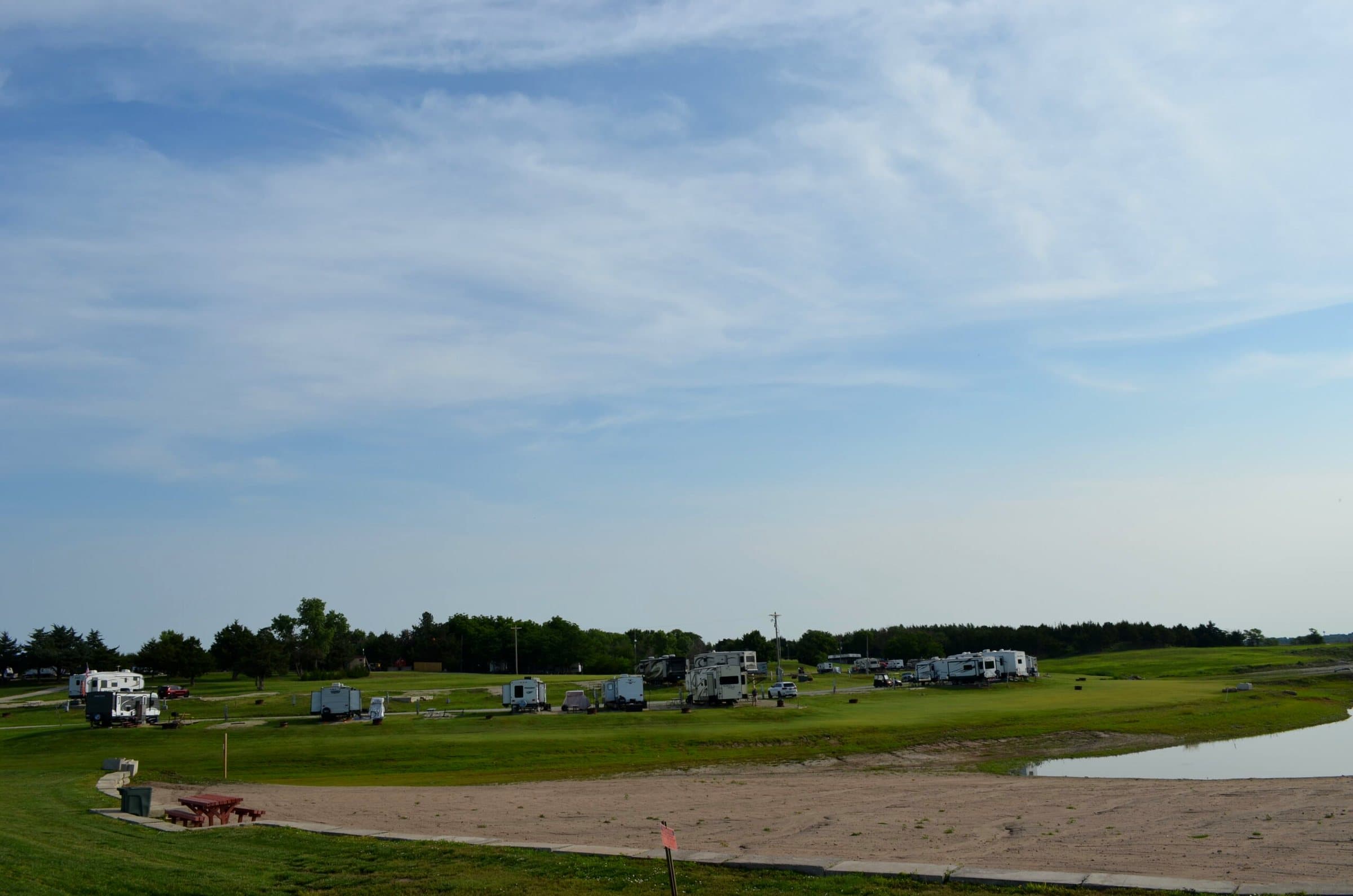 The sandy beach on the cove with RVs beyond