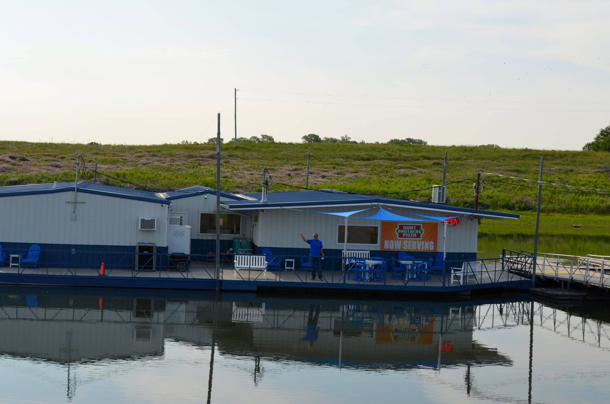The marina store reflected in calm water